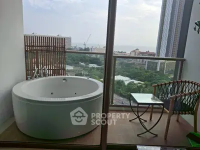 Luxurious balcony with outdoor bathtub and stunning city view