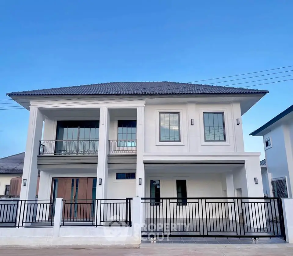Modern two-story house with sleek design and spacious balcony, perfect for family living.