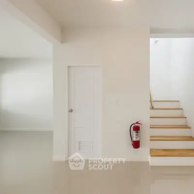 Minimalist interior with white walls and staircase, perfect for modern living.