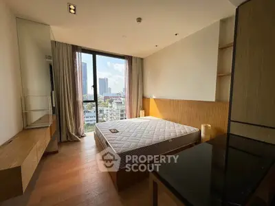 Modern bedroom with city view, featuring wooden flooring and minimalist design, perfect for urban living.