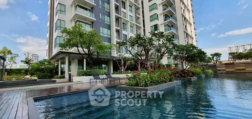 Luxurious condominium with stunning pool and lush garden view