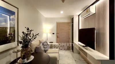 Modern living room with cozy sofa, stylish decor, and sleek TV setup.