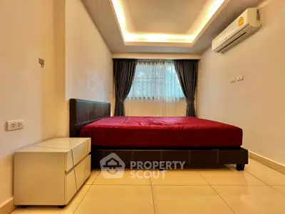 Modern bedroom with sleek design, featuring a comfortable bed, stylish curtains, and efficient air conditioning.