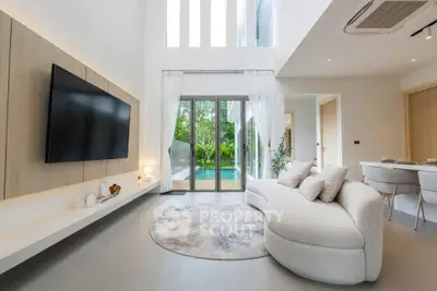 Luxurious modern living room with pool view, elegant decor, and open layout.