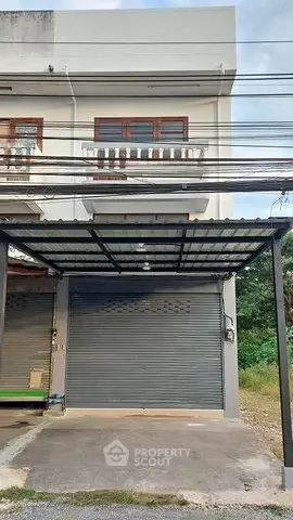 Modern townhouse exterior with garage and balcony, ideal for urban living.