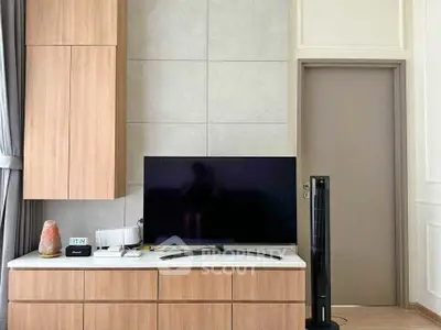Modern living room with sleek TV setup and stylish wooden cabinetry.
