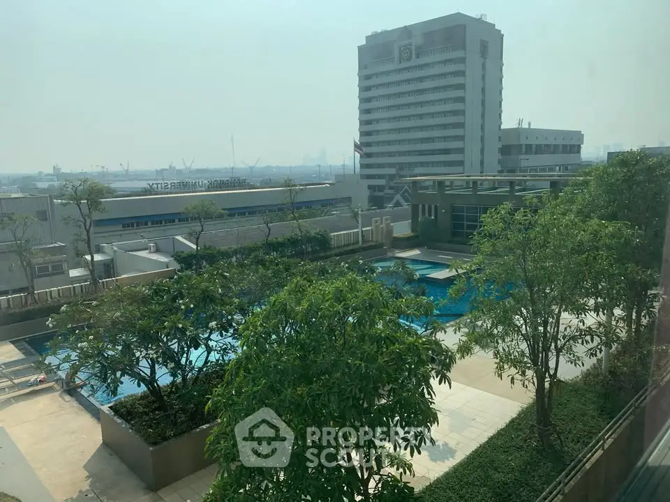 Stunning rooftop pool with lush greenery and cityscape views, perfect for relaxation and leisure.