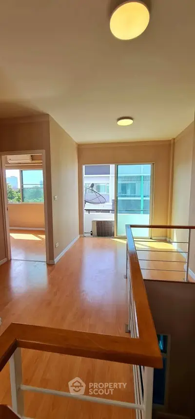 Bright open living space with wooden flooring and large windows