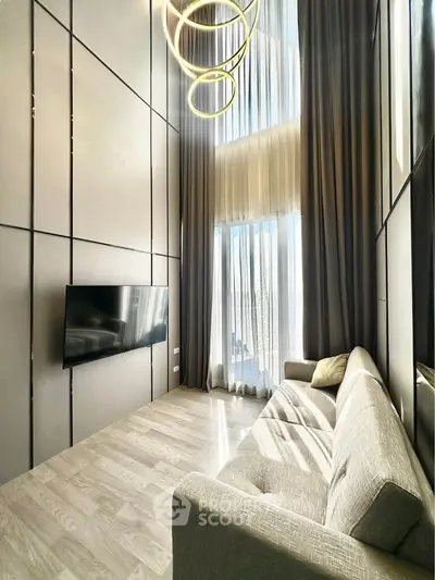 Luxurious high-ceiling living room with modern decor and large windows for natural light.