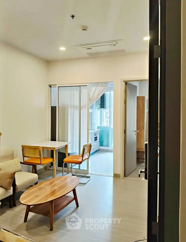 Modern living room with cozy seating and dining area, featuring a bright and inviting atmosphere.