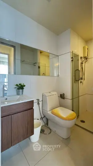 Modern bathroom with sleek fixtures and glass shower enclosure