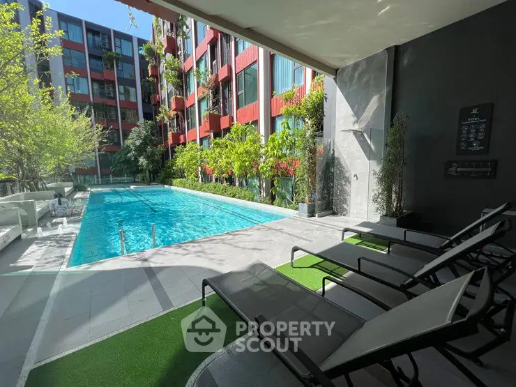 Modern apartment complex with inviting outdoor pool and lush greenery