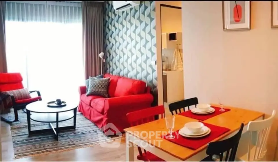 Chic living room with vibrant red sofa and modern dining area