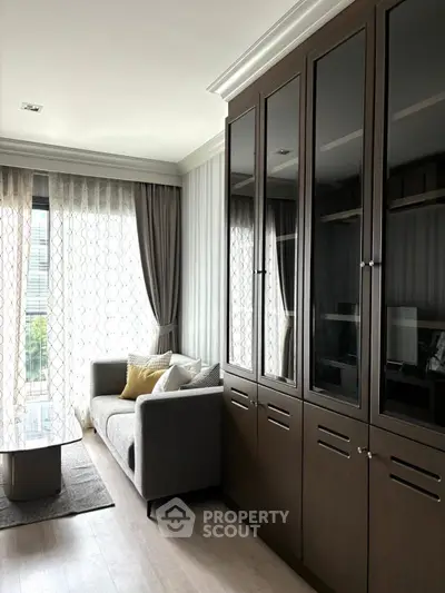 Modern living room with elegant cabinetry and large window for natural light.