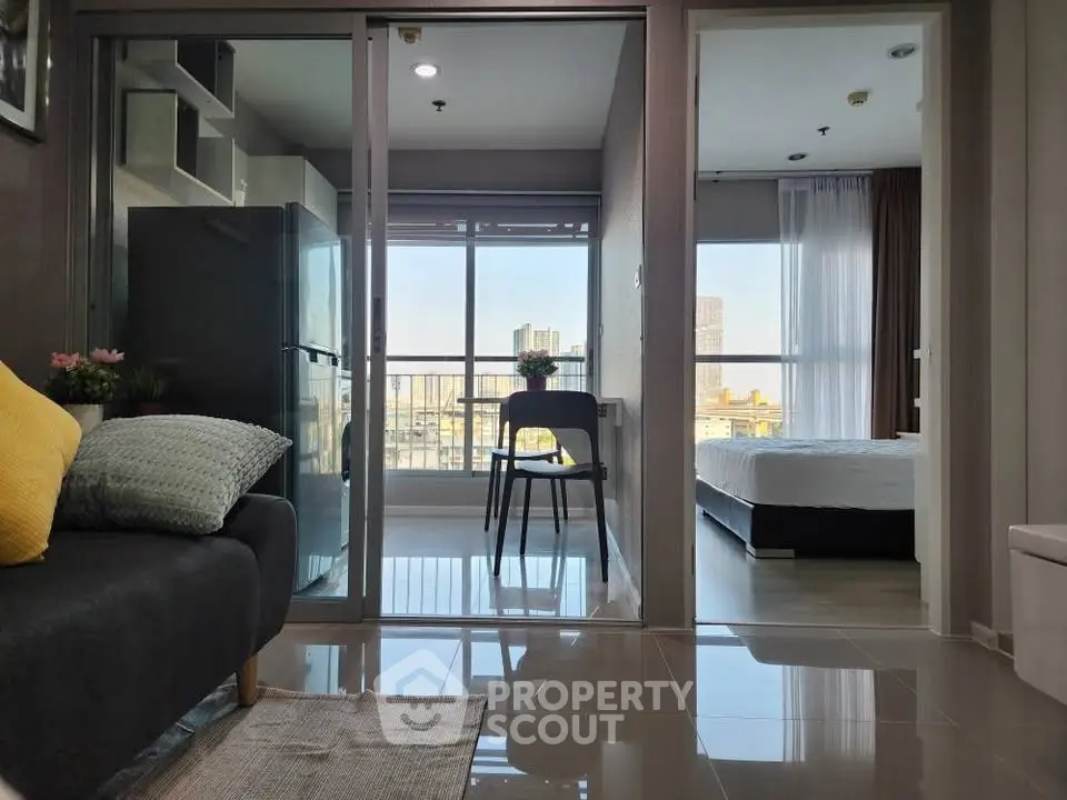 Modern apartment with open layout, balcony view, and stylish furnishings in urban setting.