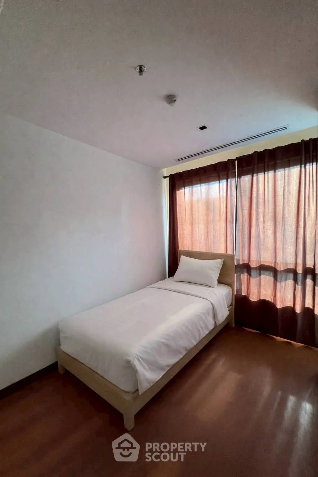 Cozy single bedroom with natural light and minimalist decor