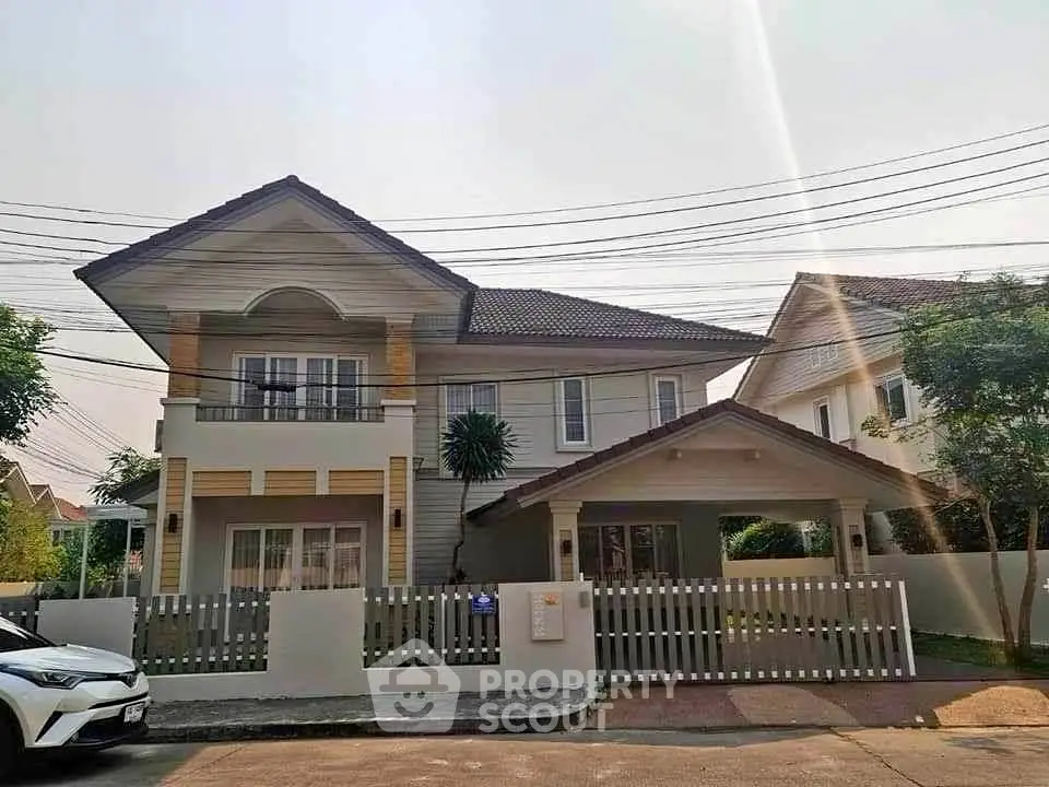 Charming two-story house with a modern design and spacious front yard in a serene neighborhood.