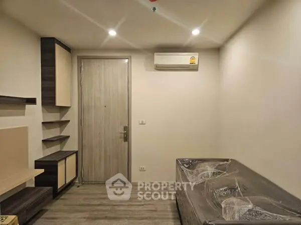 Modern living room with minimalist design and air conditioning unit.