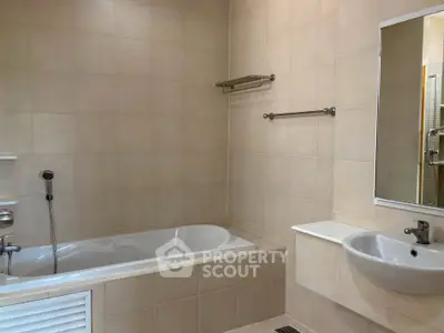 Spacious bathroom with bathtub and modern fixtures in a contemporary home.
