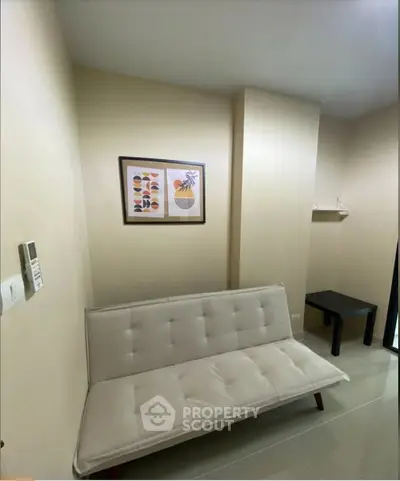 Cozy living room with modern decor and comfortable seating in a stylish apartment.