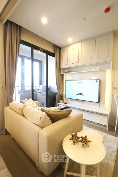 Modern living room with elegant decor and large sliding glass doors leading to a balcony.