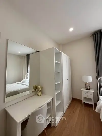 Modern bedroom with sleek white furniture and elegant decor