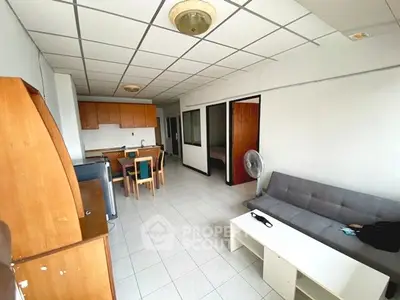 Spacious living room with open layout and modern furnishings in a cozy apartment.
