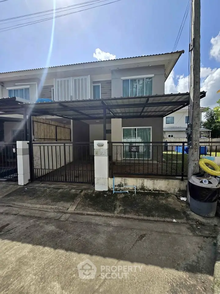 Charming two-story townhouse with gated entrance and covered parking in a serene neighborhood.