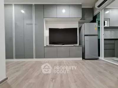 Modern living room with sleek cabinetry and stainless steel appliances