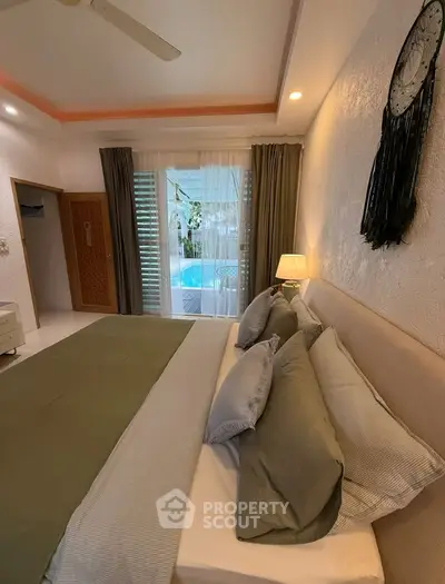 Luxurious bedroom with pool view, elegant decor, and cozy ambiance for ultimate relaxation.