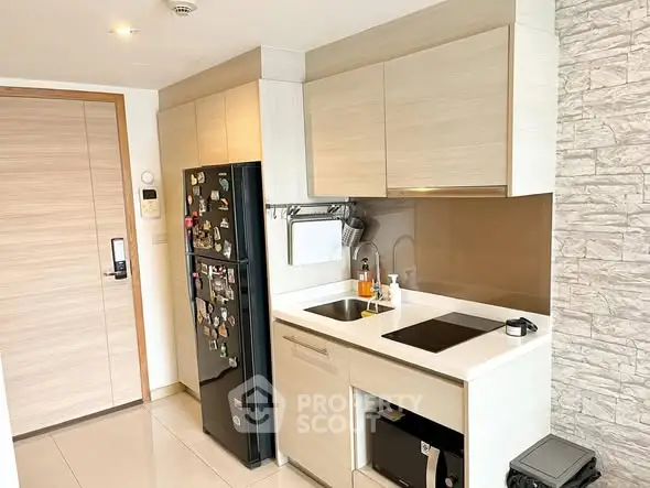 Modern kitchen with sleek cabinetry and built-in appliances in a compact layout.
