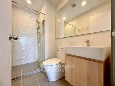 Modern bathroom with sleek fixtures and glass shower enclosure