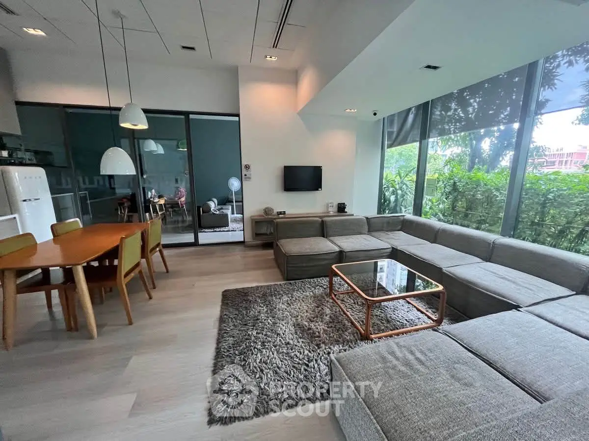 Spacious modern living room with large windows and stylish furniture