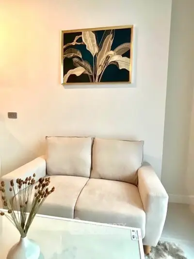 Cozy living room with elegant sofa and stylish wall art, perfect for modern interiors.