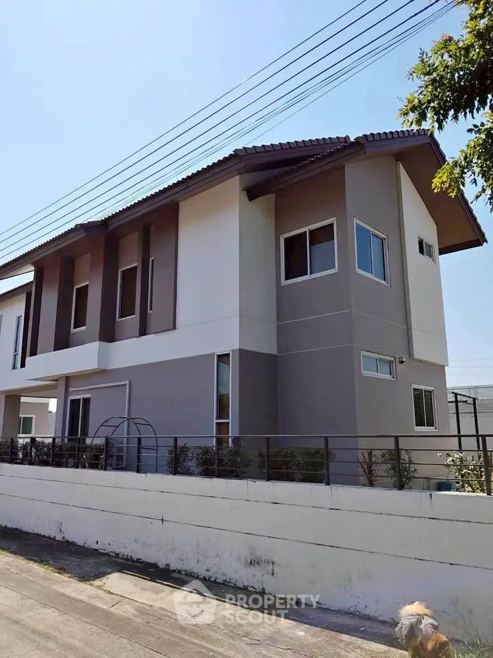 Modern two-story house with sleek design and large windows, perfect for family living.