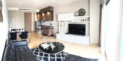 Modern open-layout living room with sleek kitchen and stylish decor