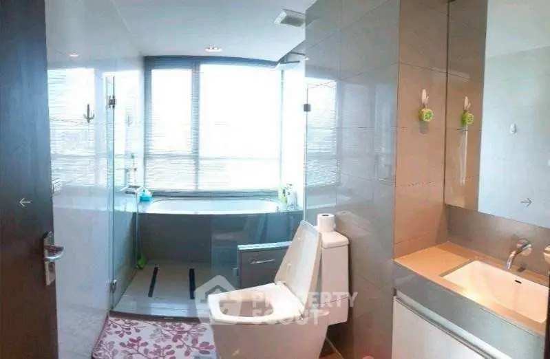 Modern bathroom with large windows and sleek fixtures in a contemporary home.