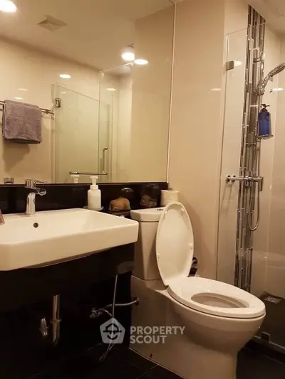 Modern bathroom with sleek fixtures and glass shower enclosure