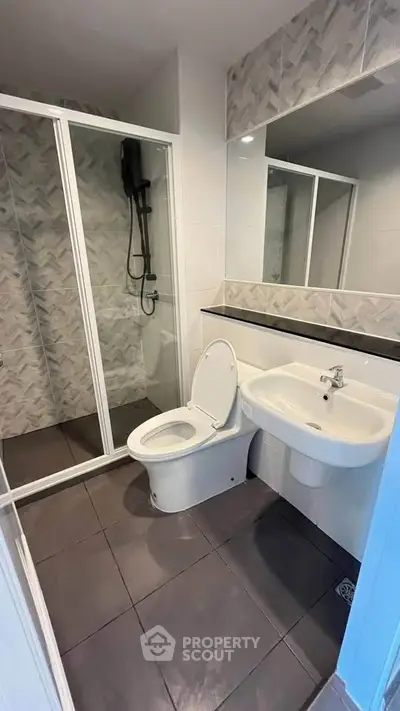 Modern bathroom with sleek shower and elegant fixtures in contemporary apartment.