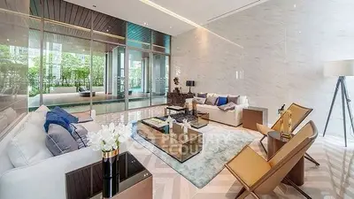 Luxurious modern living room with elegant decor and pool view, perfect for relaxation and entertaining.
