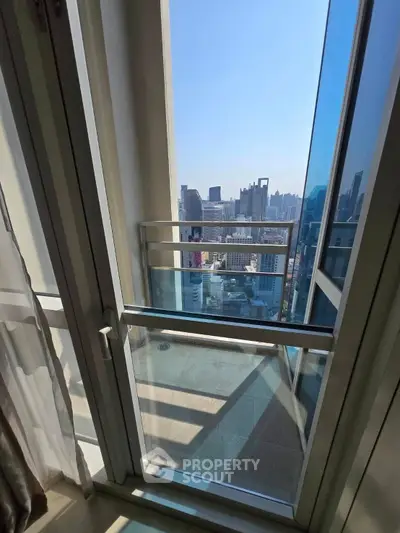 Stunning high-rise balcony view with cityscape panorama and modern glass railing.
