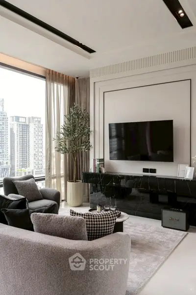 Luxurious modern living room with city view, elegant furniture, and large TV setup.
