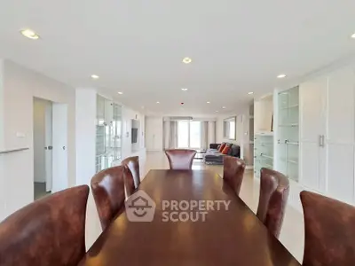 Spacious open-plan living and dining area with elegant furnishings and ample natural light.