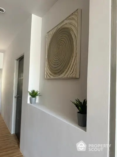 Modern hallway with stylish decor and wooden flooring