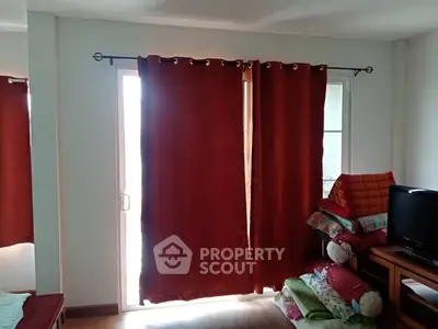 Cozy living room with red curtains and natural light