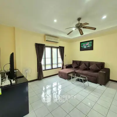 Spacious living room with modern decor and ceiling fan