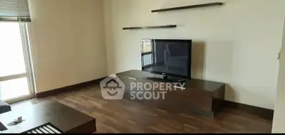 Modern living room with sleek TV stand and wooden flooring