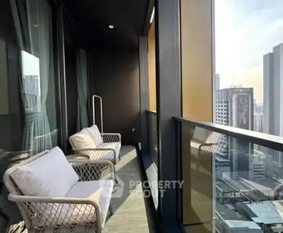 Luxurious high-rise balcony with stunning city view and cozy seating area.
