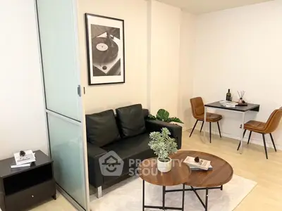 Modern living room with sleek black sofa and stylish dining area
