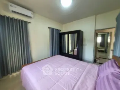 Cozy bedroom with modern furnishings and ample natural light